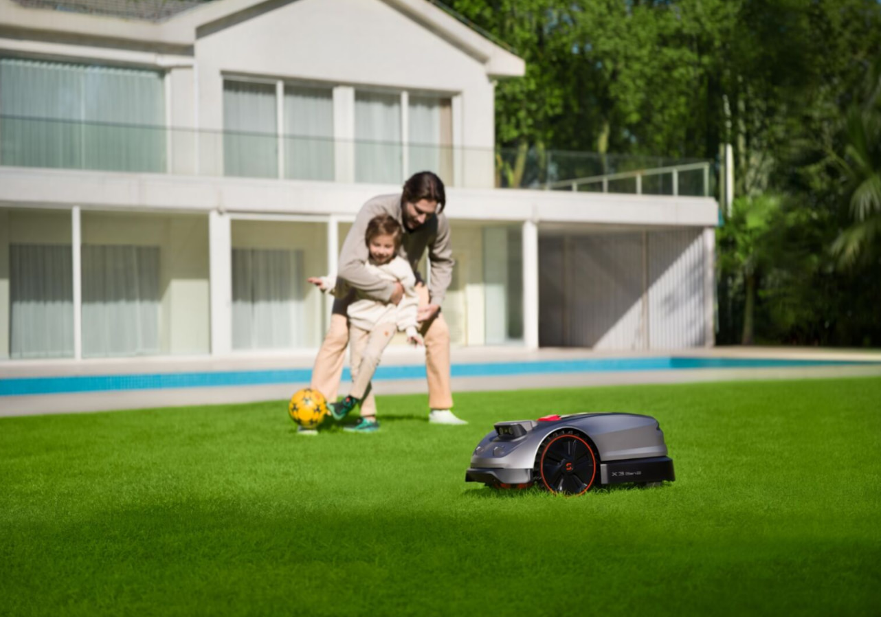 Sunseeker X3 Gen 2 safely mowing a lawn while children play nearby