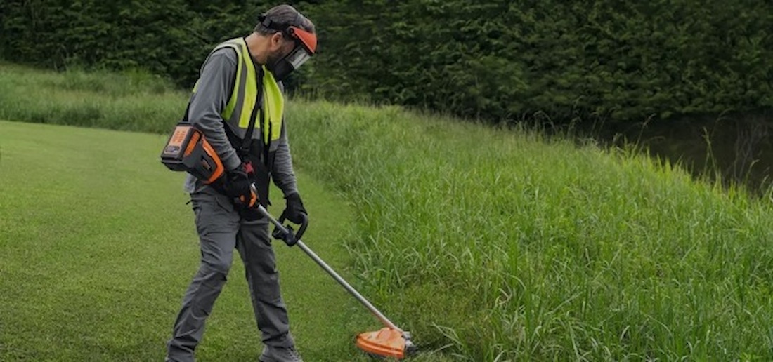 Man Using a Weed Trimmer